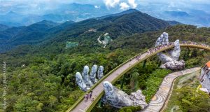 Golden Bridge lifting by two giant hands in the tourist resort on Ba Na Hill in Da Nang, Vietnam.